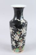 A CHINESE FAMILLE NOIRE ALMOND BLOSSOM VASE. 11ins high.