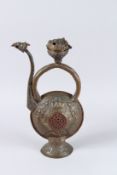 AN EARLY ISLAMIC METAL EWER with embossed decoration, turquoise beads and bird spout. 19ins high.
