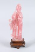 A CHINESE CARVED JADEITE GROUP of a woman and a boy. 8.5ins high, on a wooden stand.