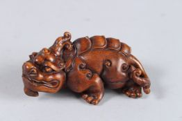 A CARVED WOOD FOO DOG. 3ins long.