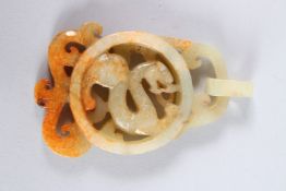 A LATE 19TH CENTURY CHINESE JADE PENDANT depicting dragon motif, the carving openwork.