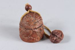 A CHINESE CARVED WOOD INRO on a rope.