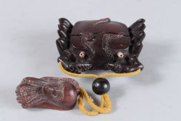 A CHINESE CARVED WOOD CRAB INRO on a rope.