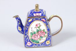 A SMALL PERSIAN BLUE ENAMEL TEAPOT AND COVER, painted with flowers. 3.5ins high.