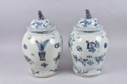 A LARGE PAIR OF CHINESE BLUE AND WHITE PORCELAIN JARS AND COVERS, painted with various objects.