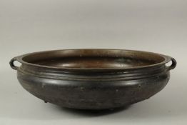 A LARGE 19TH CENTURY INDIAN OR SOUTHEAST ASIAN BRONZE TWIN HANDLE URLI. 59cms diameter.