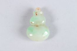 A SMALL JADE GOD PENDANT.