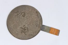 A JAPANESE BRONZE HAND MIRROR, one side with calligraphy, birds and flowers. 6.5ins diameter.