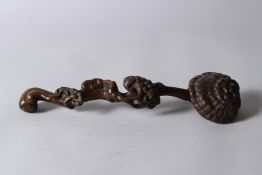 A CHINESE CARVED WOOD RUYUI SCEPTRE, of naturalistic form. 33cms long.