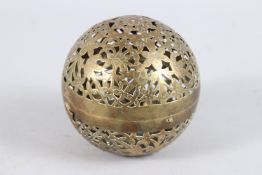 A 19TH CENTURY INDIAN OPEN WORKED BRASS SPHERICAL HAND WARMER. 4ins diameter.