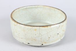 A CHINESE CELADON GLAZE POTTERY CIRCULAR BOWL. 20cms diameter.