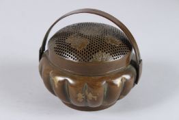 A GOLD SPLASH BRONZE CIRCULAR CENSER with handle. 4.5ins diameter.