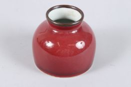 A CHINESE PORCELAIN WATER POT, red glaze with six character mark to the base. 8cms high.