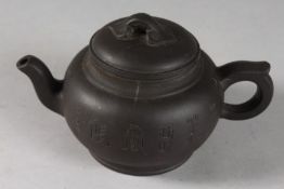 A CHINESE BLACK YIXING TEAPOT, with impressed mark to base.