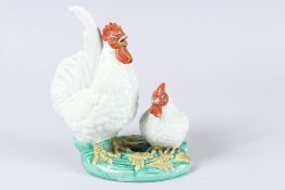 A 19TH CENTURY GROUP OF TWO ROOSTERS, Famille Rose. 7.5ins high.