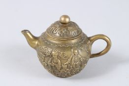 A SMALL CHINESE BRONZE TEAPOT AND COVER, decorated with figures. 3ins diameter.