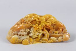 A CHINESE CARVED HARDSTONE BOULDER. 7.25ins high.