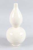 A CHINESE ETCHED CREAM GLAZED DOUBLE GOURD VASE. 11ins high.