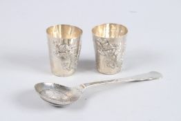 A PAIR OF CHINESE SILVER DRAGON CUPS, 2ins high, and a coin spoon (3).