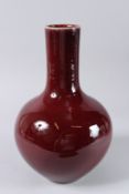 A CHINESE COPPER RED VASE. 13ins high.