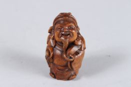 A CARVED WOOD CHINESE MAN NETSUKE. 2.25ins high.