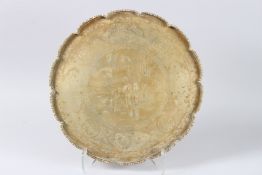 A CHINESE BONE CIRCULAR SHAPED DISH engraved with Chinese figures. 16ins diameter.