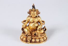 A TIBETAN GOLD PLATED ALLOY OF DZAMBHALA, the Buddhist God of wealth. Depicted with a fierce