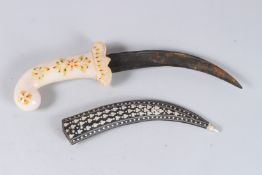 A MUGHAL HARDSTONE DAGGER with silvered metal sheath. 13ins long.