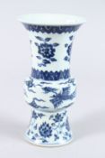 A CHINESE PORCELAIN BLUE AND WHITE GU SHAPE VASE, painted with phoenix and flowers. 21.5cms high.