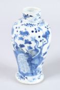 A 19TH CENTURY CHINESE BLUE AND WHITE VASE with peacocks. 7ins high.