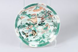 A CHINESE FAMILLE VERTE DISH. 11ins diameter.