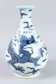 A CHINESE BLUE AND WHITE BULBOUS DRAGON VASE. 13ins high.
