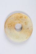 A SMALL CHINESE CARVED JADE BI DISC. 2ins diameter.