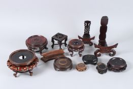 A COLLECTION OF ELEVEN VARIOUS CHINESE WOODEN STANDS.