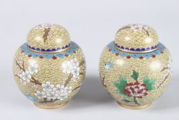 A PAIR OF JAPANESE CLOISONNE ENAMEL GINGER JARS AND COVERS. 4.5ins high.