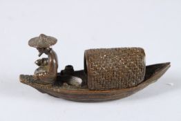 A JAPANESE OKIMONO BRONZE FISHERMAN AND BOAT. 8.5ins long.