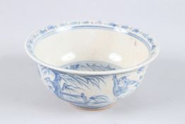 A SMALL CHINESE BLUE AND WHITE BOWL decorated with young boys. 5.5ins diameter.