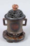 A LATE QING OR EARLY REPUBLIC PERIOD CHINESE BRONZE INCENSE BURNER WITH A TRIPOD BASE. It features a