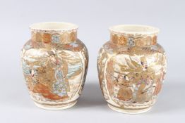 A PAIR OF JAPANESE SATSUMA BULBOUS VASES with panels of birds and figures. 7.5ins high.