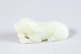 A 19TH CENTURY CHINESE JADE CARVING DEPICTING A DOG. 3ins x 1ins.