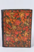 A 19TH CENTURY PERSIAN PAINTED LEATHER FLORAL BOOK COVER. 12ins x 9.5ins.