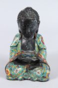 A CHINESE CLOISONNE FIGURE OF A SEATED BUDDHA, hands clasped together. 22cms high.