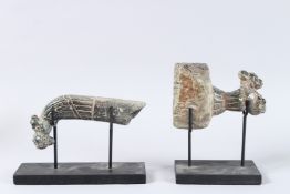 TWO EARLY INDIAN CARVED STONE ANIMALS on wooden stands. 9ins high x 7ins long.