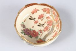 A JAPANESE SATSUMA CIRCULAR BOWL painted with birds, flowers and bamboo. 3.5ins diameter.