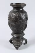 A 19TH CENTURY JAPANESE BRONZE VASE ON STAND, with panels of birds in relief, supported on three