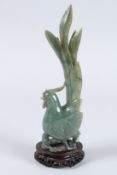 A CHINESE CARVED AGATE BIRD. 10ins high, on a wooden stand.