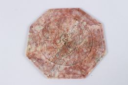 A CHINESE MOTTLED JADE OCTAGONAL DISH, carved with dragons. 6.5ins.