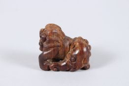 A CARVED WOOD KYLIN NETSUKE. 1.5ins.