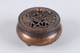 A GOOD CHINESE BRONZE CIRCULAR KORO AND COVER on three legs. 3ins diameter.