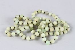 A LONG STRING OF JADE BEADS. 48ins long.